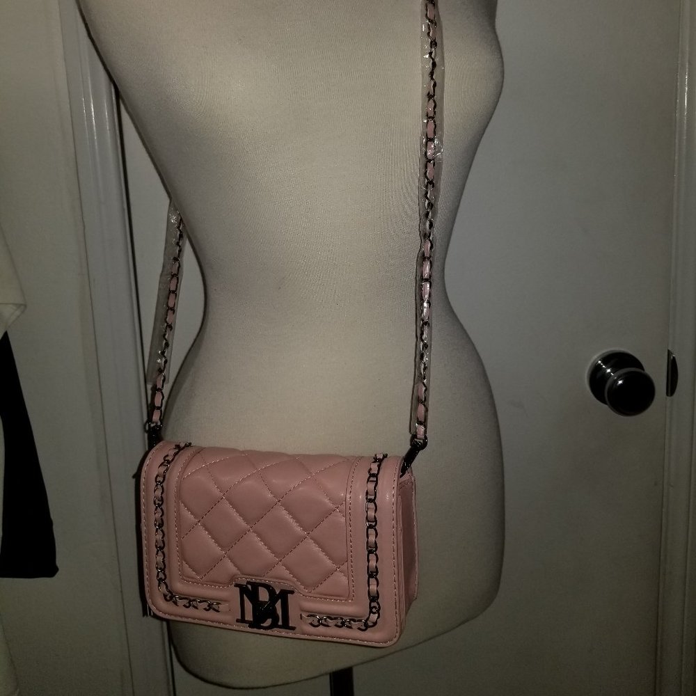 Chain accents and diamond-patterned quilting glam up this boxy crossbody bag.
